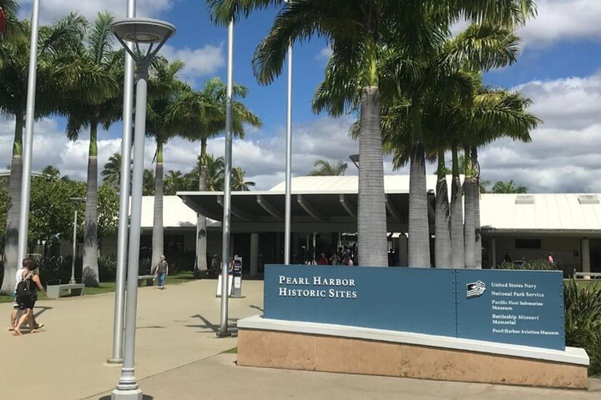 a sign in front of a building with palm trees