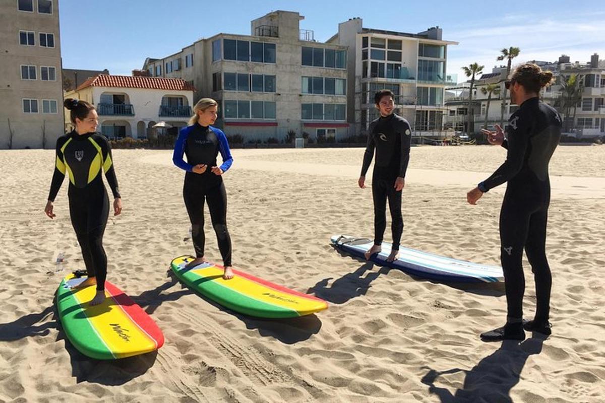 um grupo de pessoas em pé em pranchas de surfe na praia