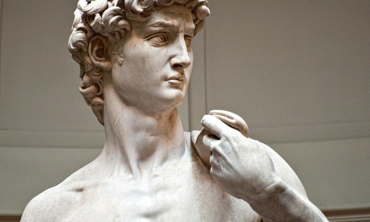 a statue of a man holding a cell phone