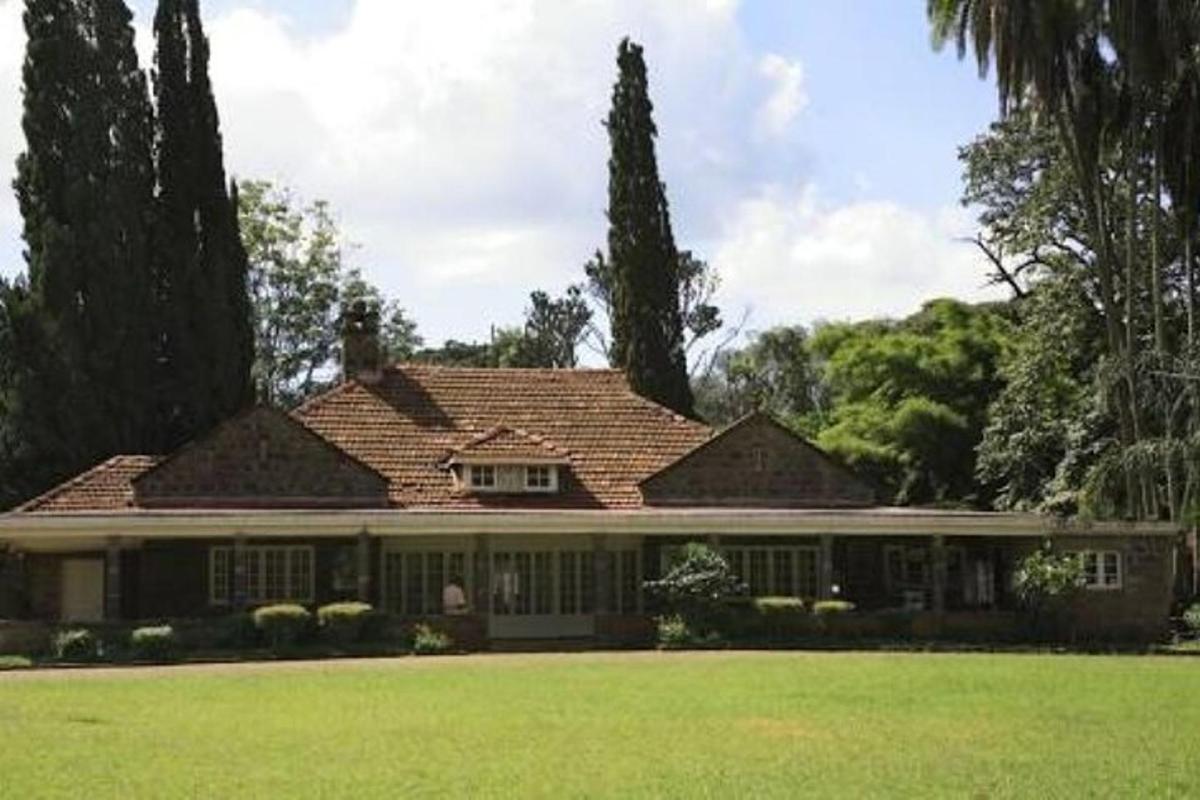 a large house with a green lawn in front of it