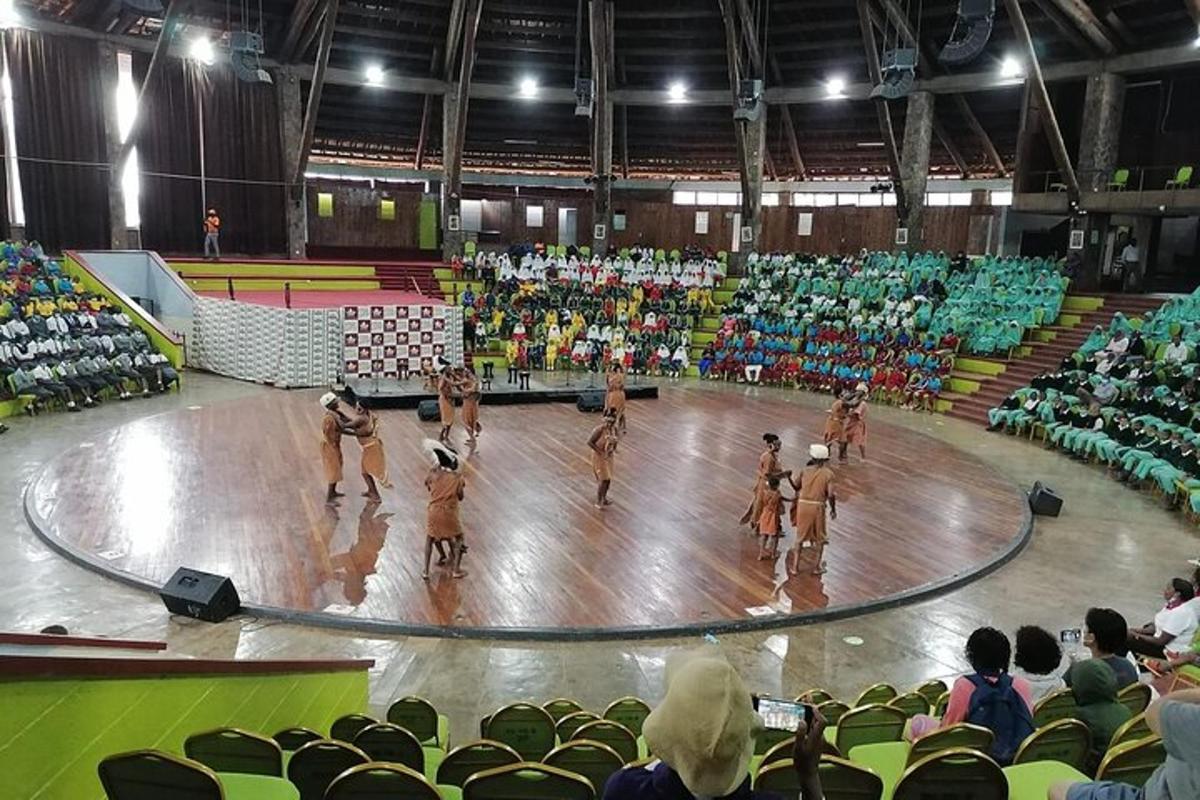 a group of girls playing volleyball in a gym
