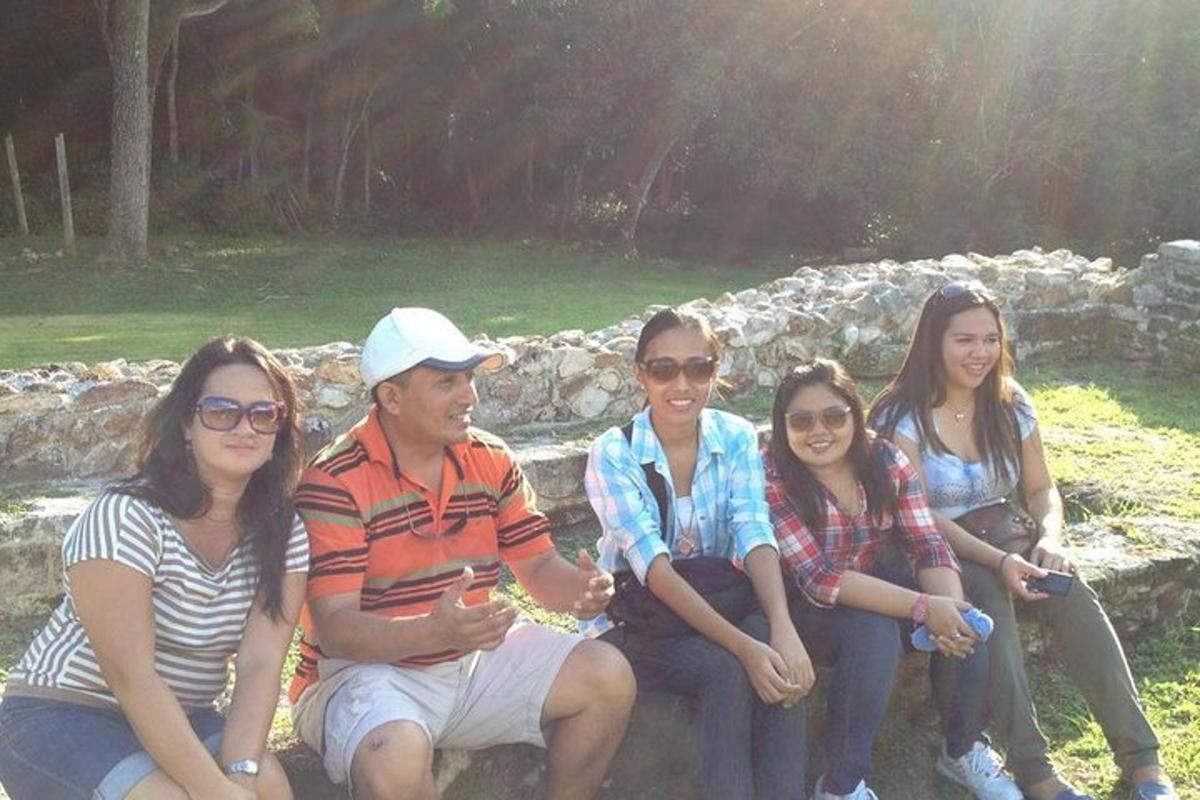 a group of people sitting on a stone wall