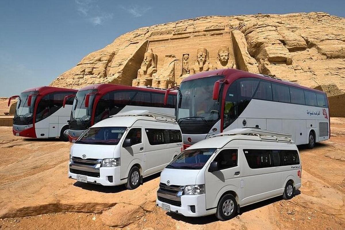 a group of buses and cars parked in the desert