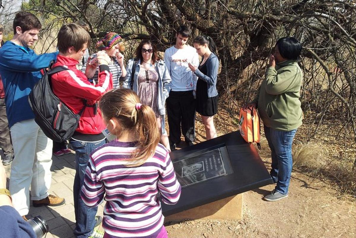 a group of people standing around a monument