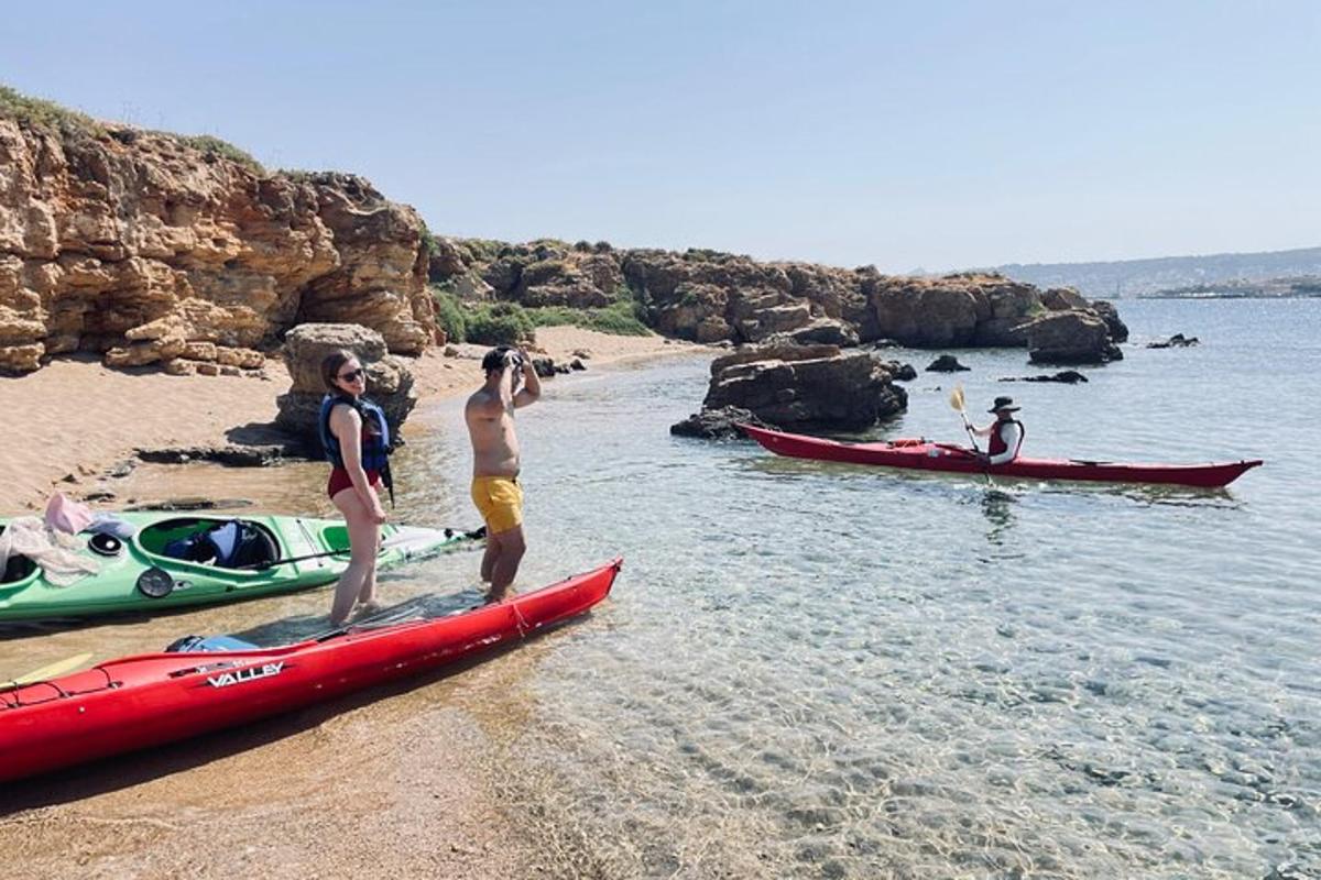 un gruppo di persone in piedi su una spiaggia accanto alle barche