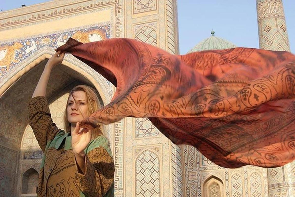 a woman holding up a sheet with a tattoo