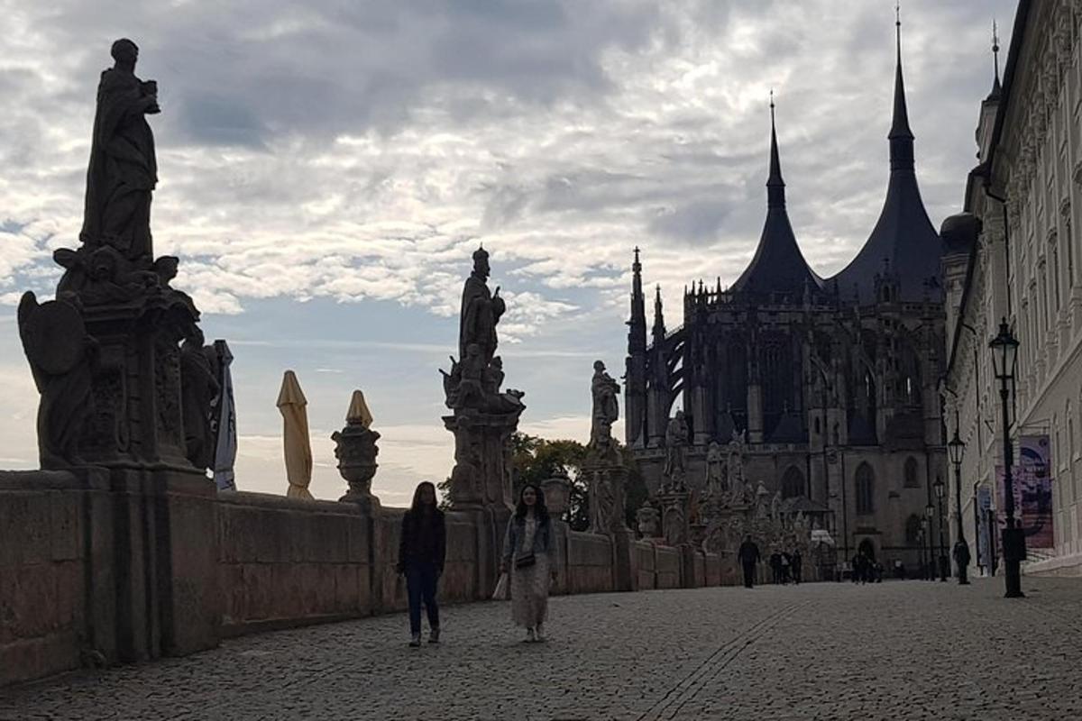 a group of people walking down a street near a castle