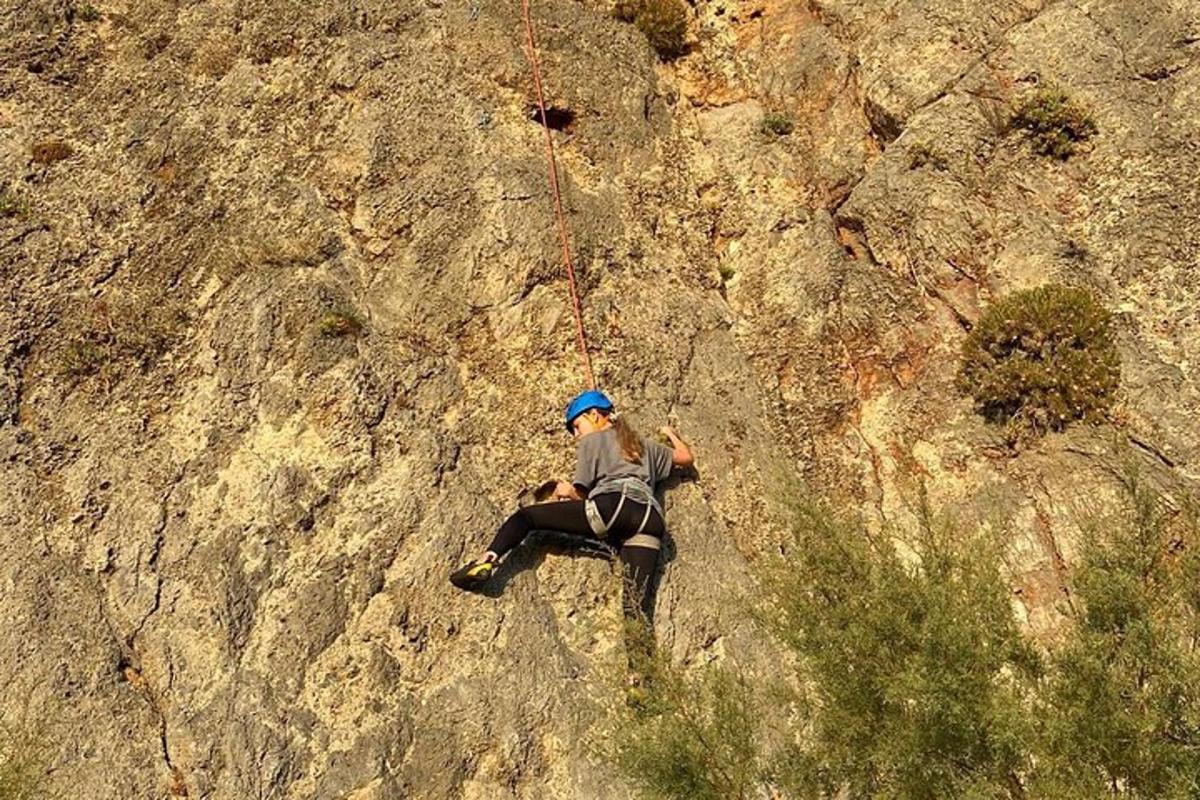 a person on a rope climbing on a mountain