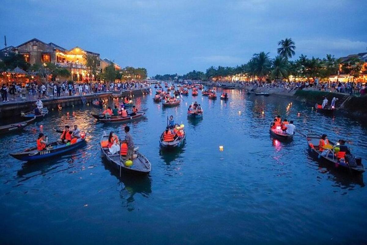 a group of people in boats on a river at night