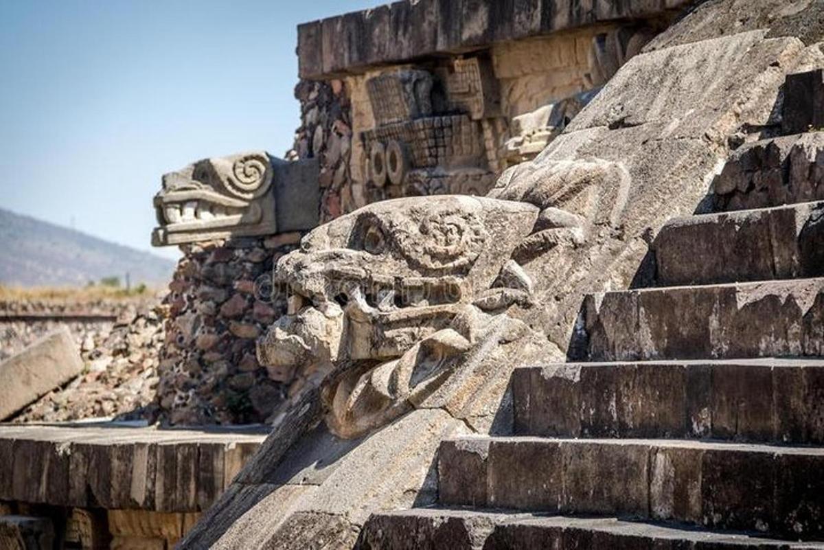 a stone lion statue on the side of a building
