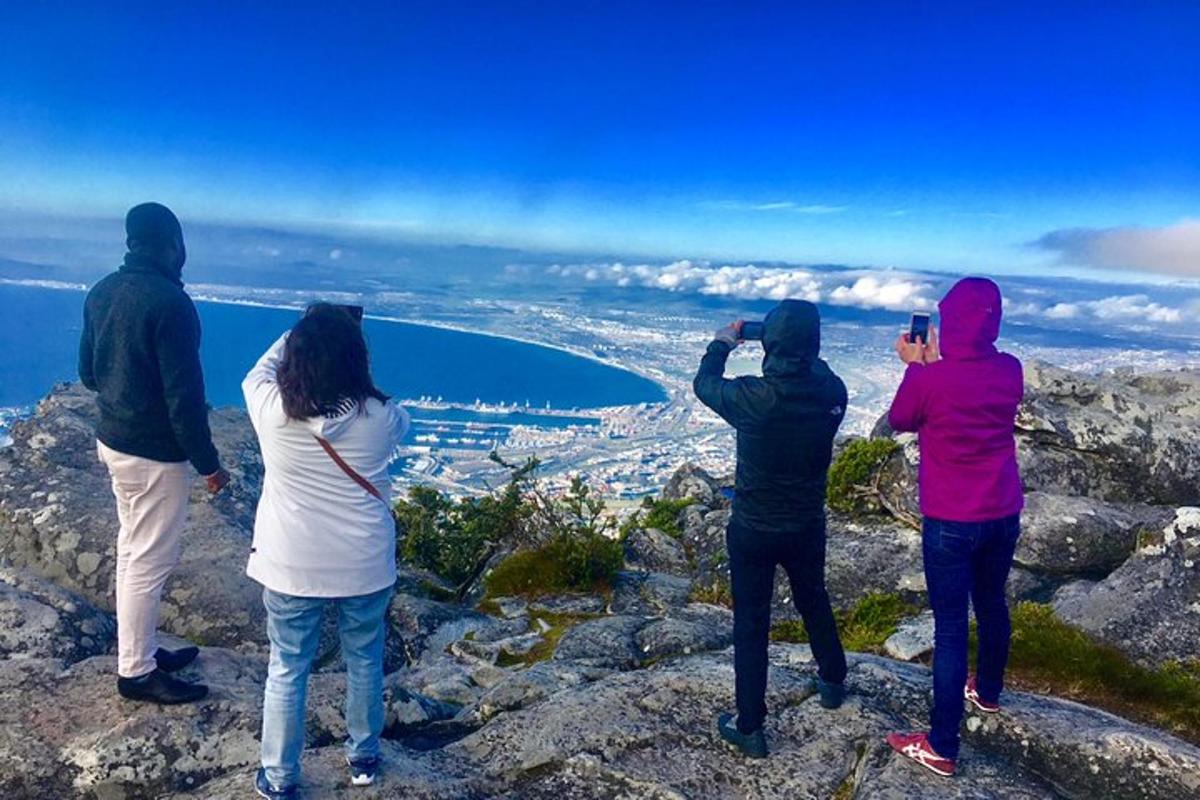 a group of people standing on top of a mountain