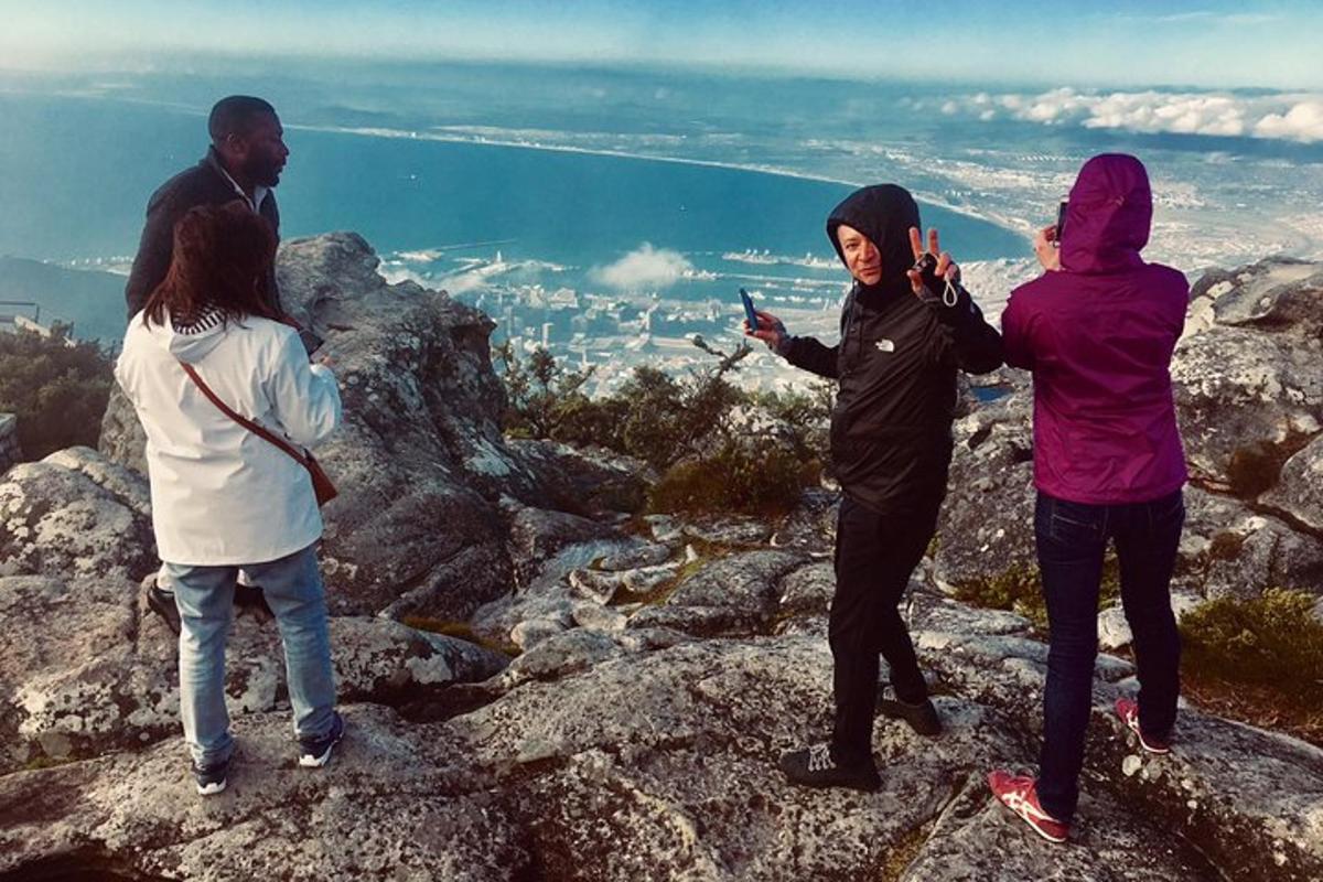 a group of people standing on top of a mountain
