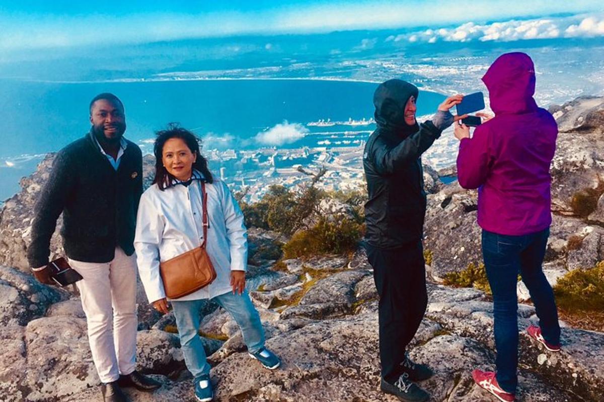 a group of people standing on top of a mountain