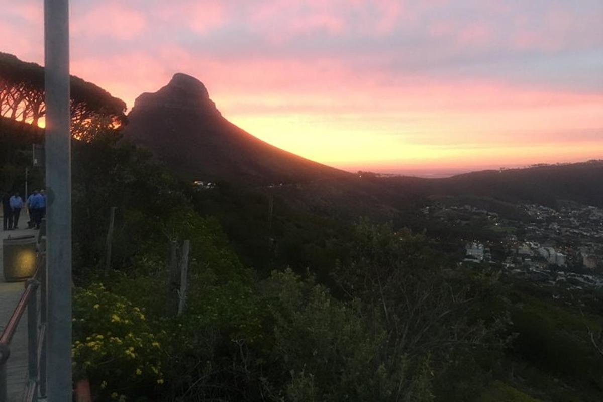a view of a mountain with the sunset in the background