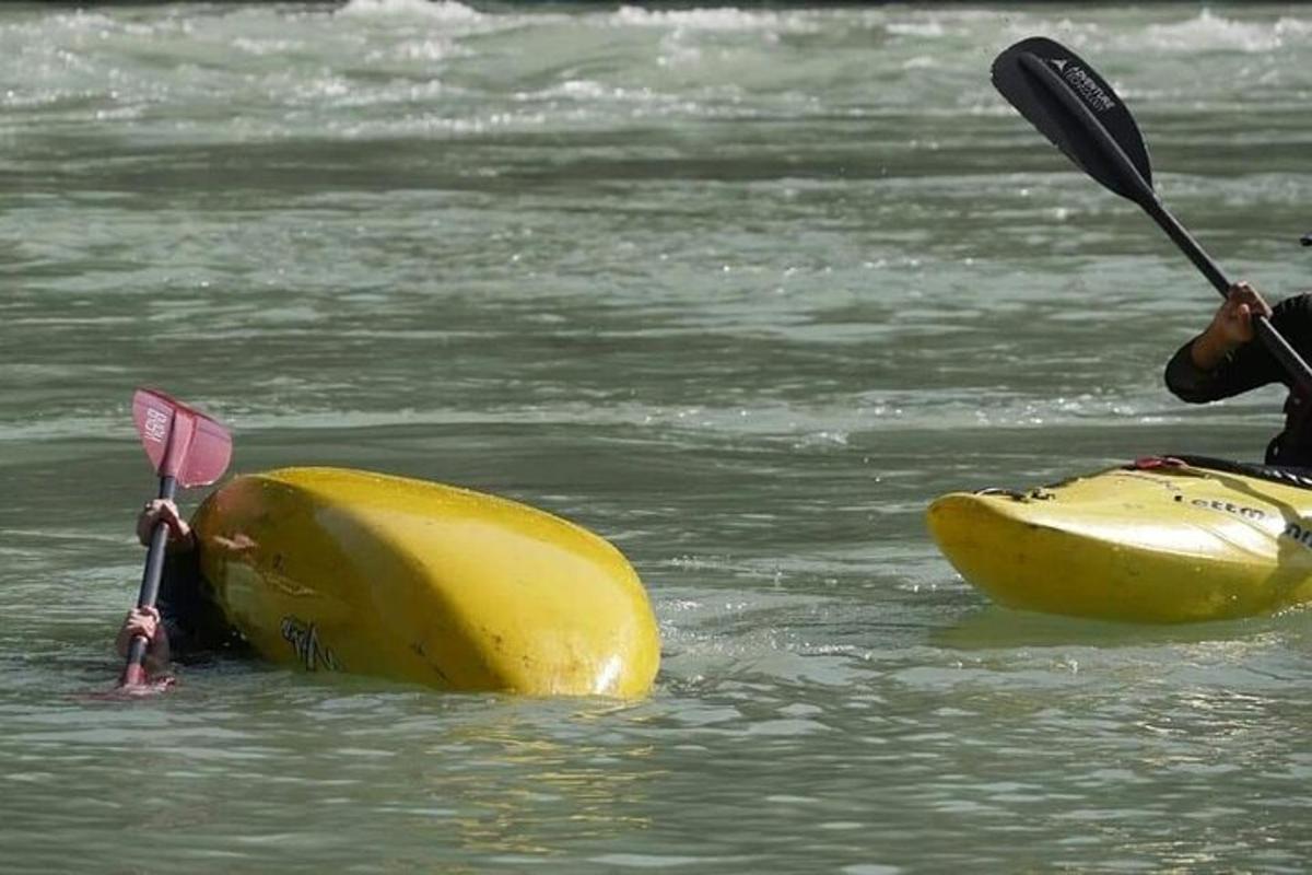 a person in a kayak in the water with a paddle