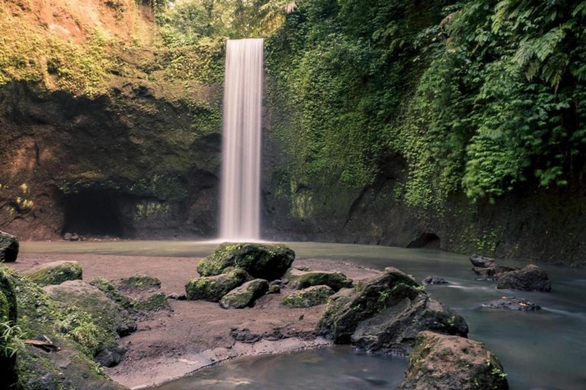 a waterfall in the middle of a river with rocks