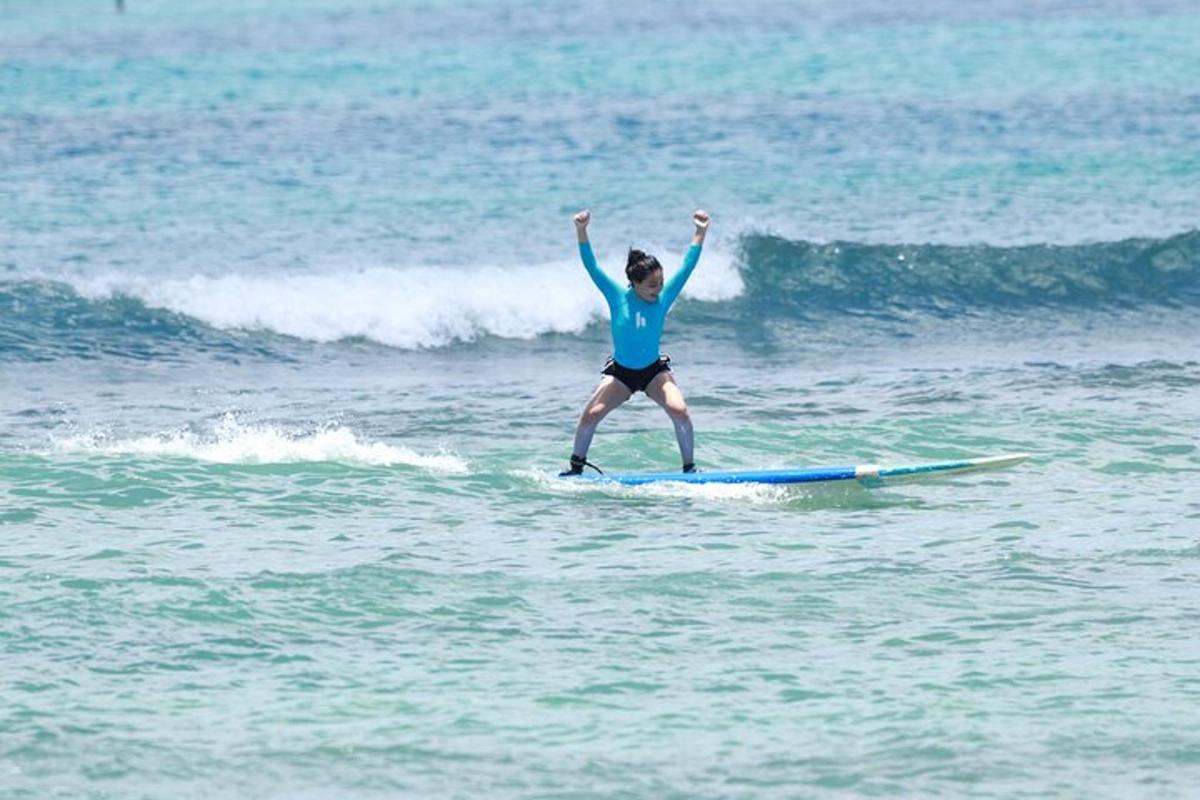 a woman riding a wave on a surfboard in the ocean
