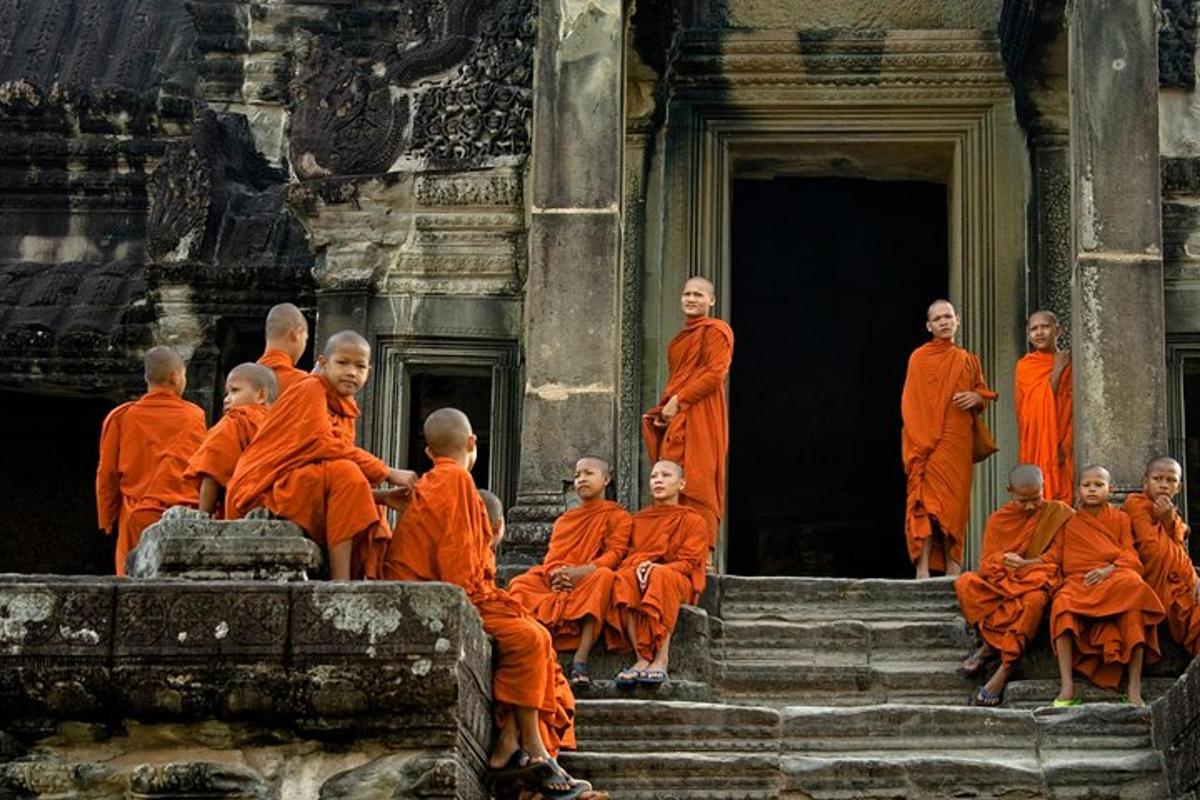 a group of monks sitting on the steps of a building