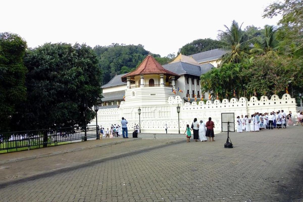 a group of people standing in front of a white building