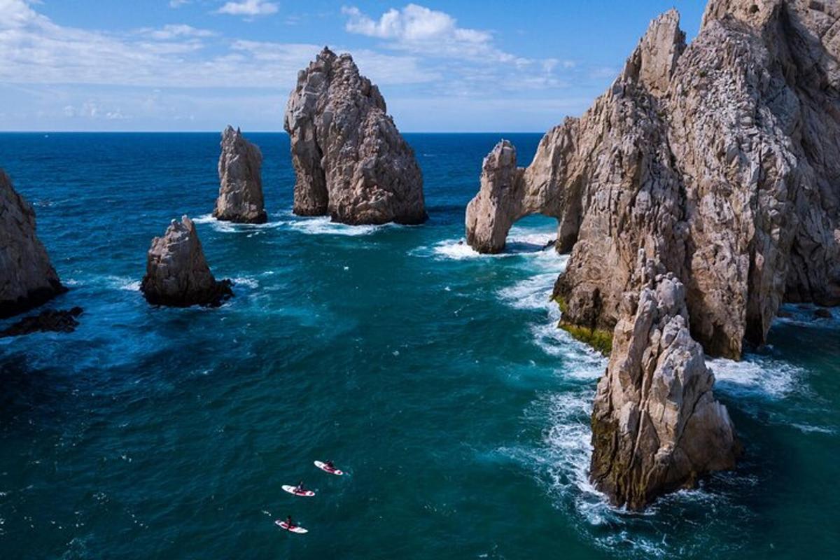 un grup de roci în ocean cu oameni în apă