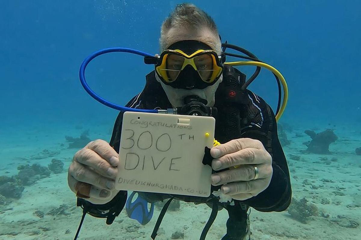 a man in the water holding a sign that says