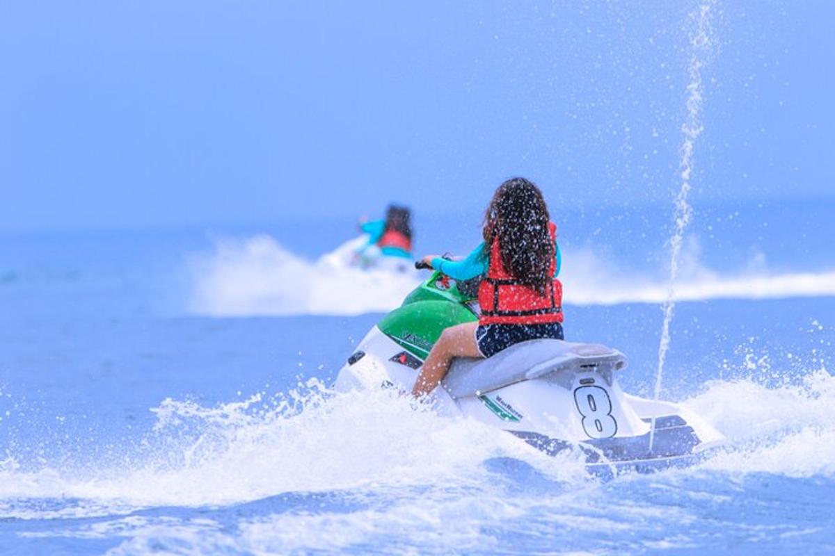 two people riding on a jet ski in the water