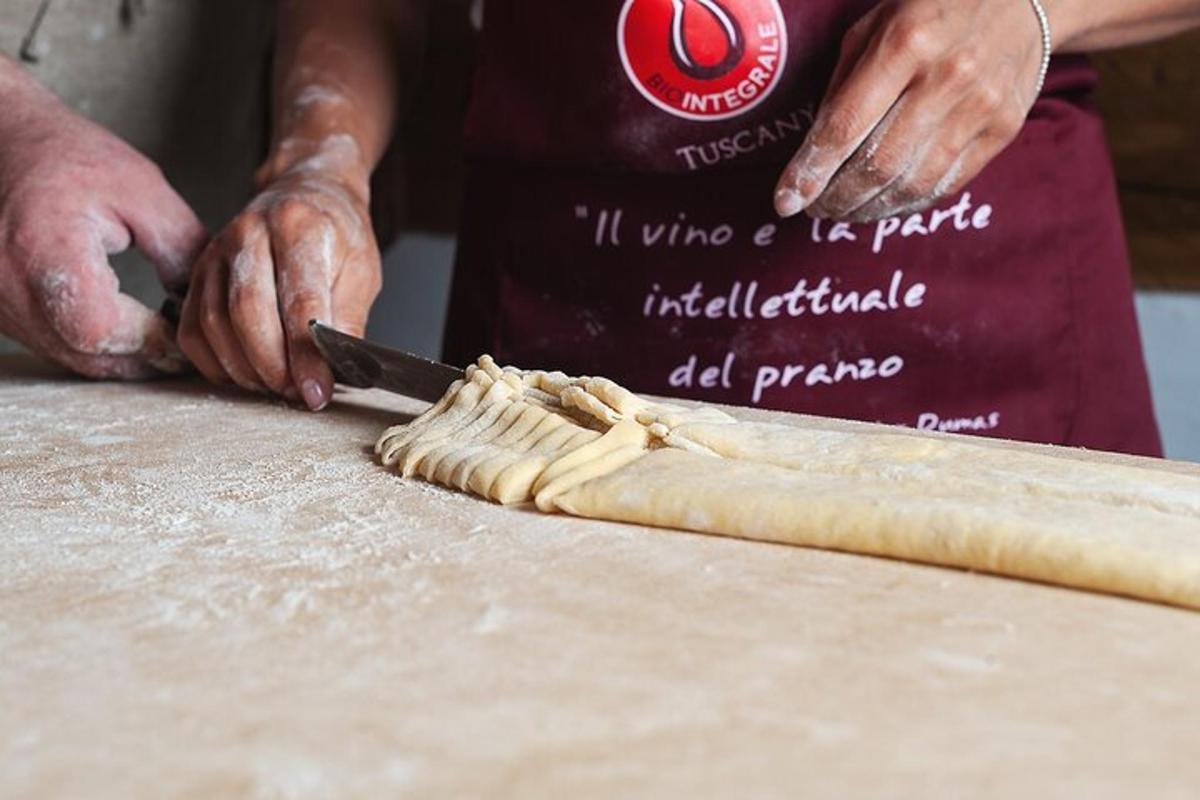 una persona che taglia un pezzo di pasta con un coltello