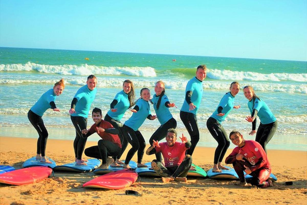 a group of people posing for a picture on the beach