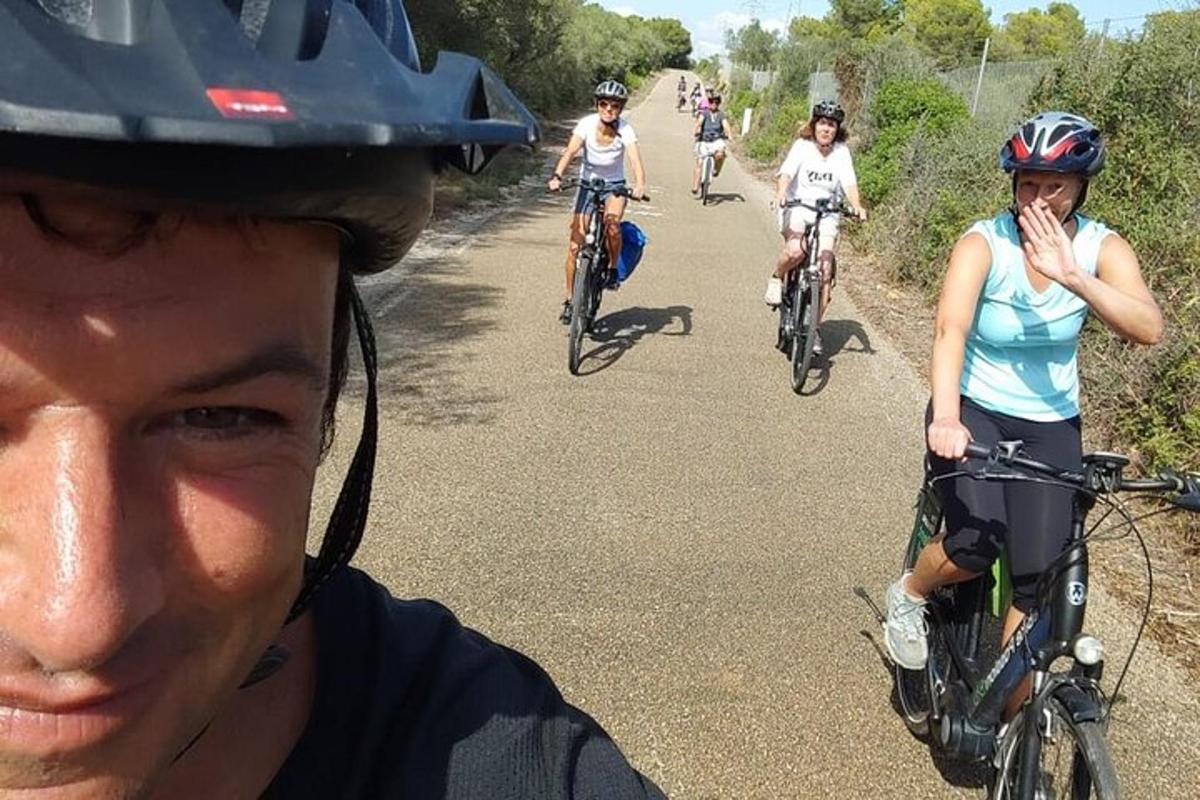 a group of people riding bikes down a road