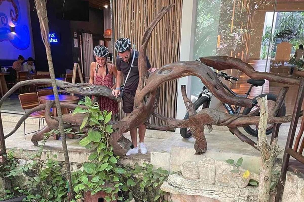 seorang lelaki dan seorang wanita berdiri di sebelah sebuah arca