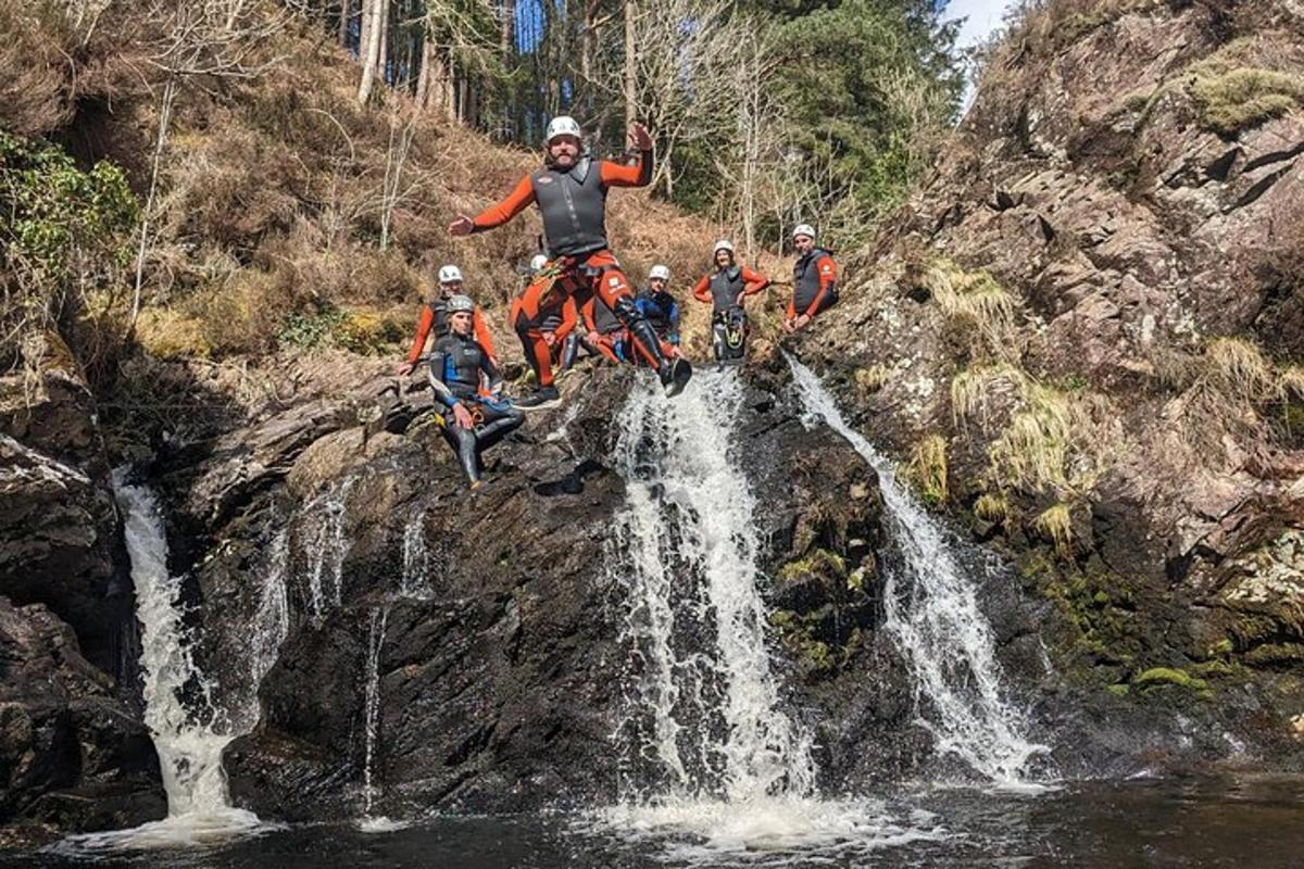 a group of people standing on a rock near a waterfall