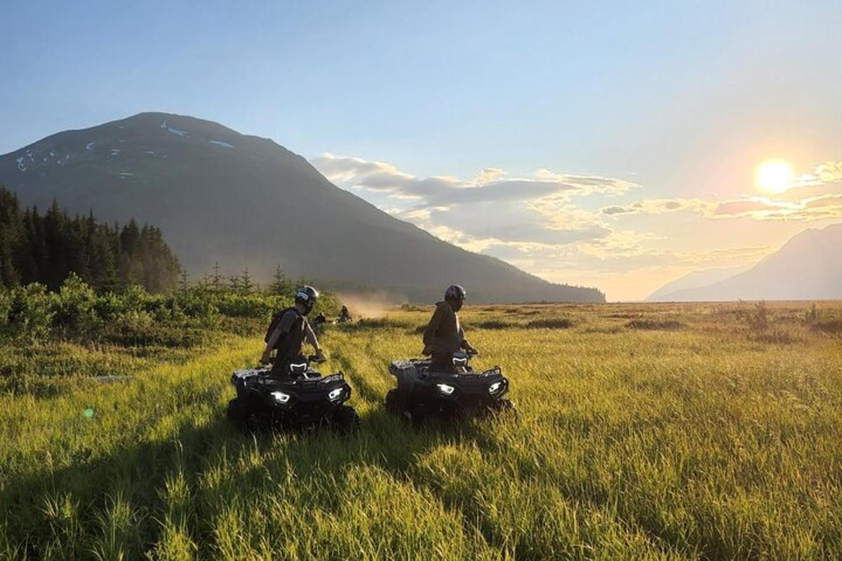 dalawang tao na nakasakay sa quad bike sa isang field