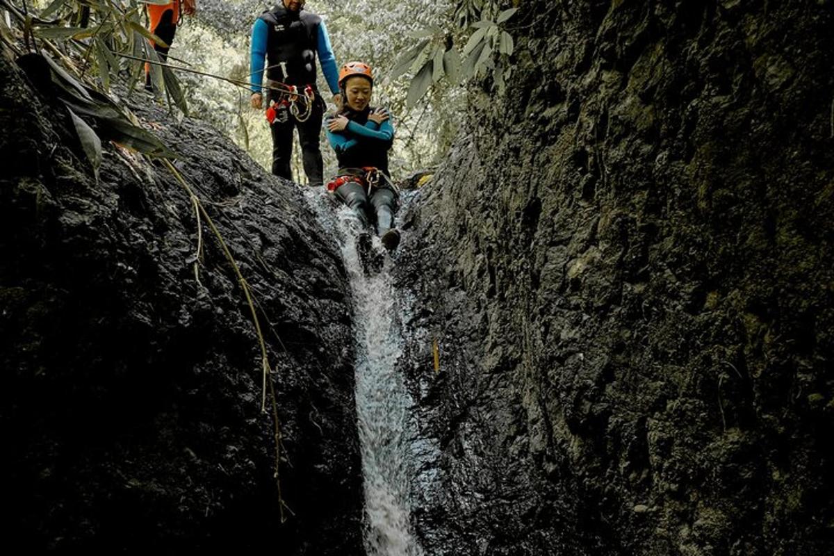 um grupo de pessoas em pé ao lado de uma cachoeira