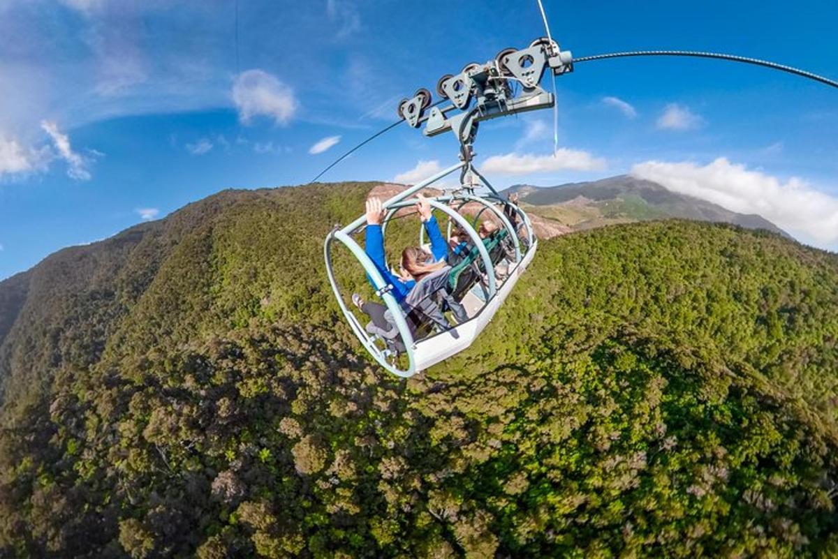 a group of people riding a gondola over a mountain