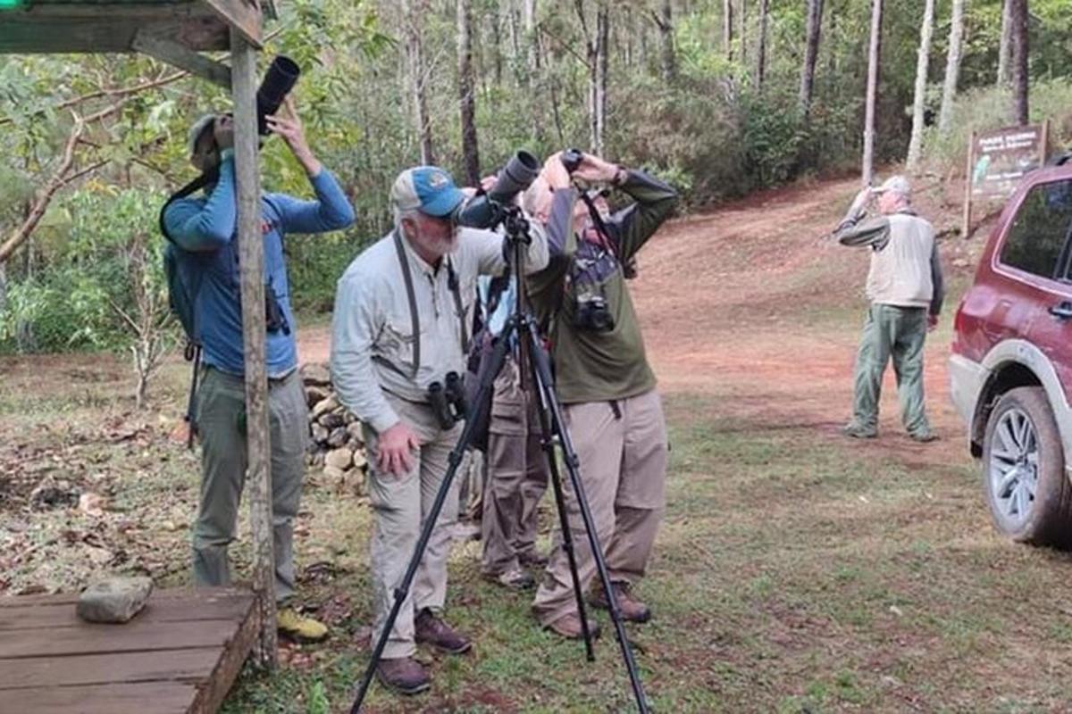 a group of people standing next to a camera