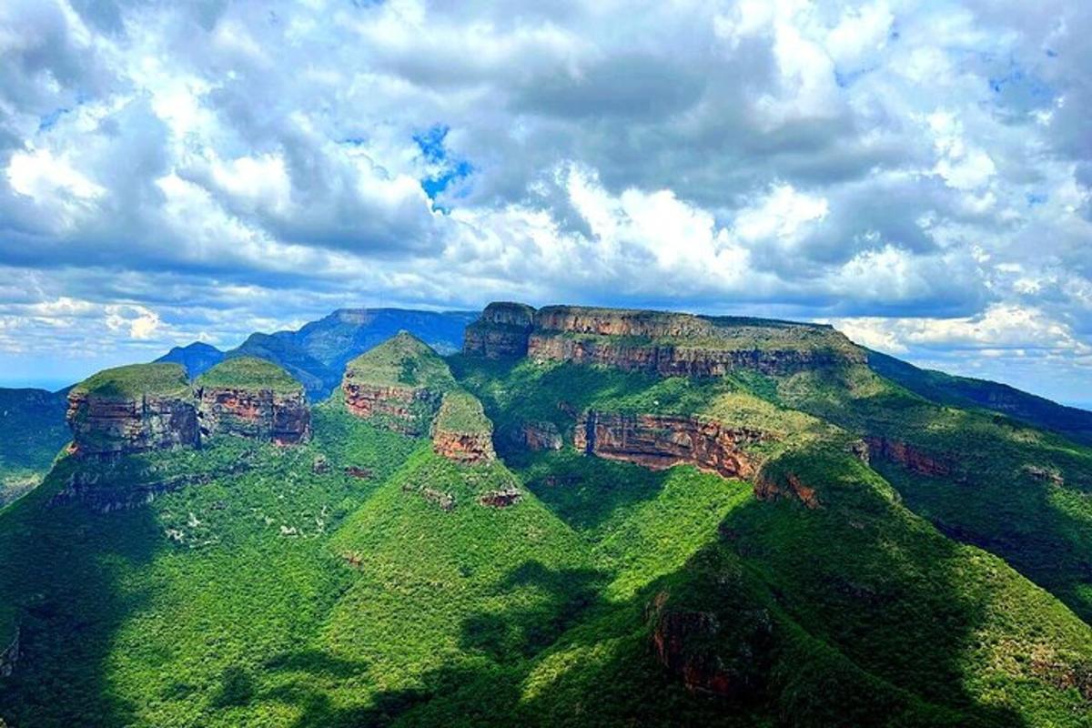 a view of the blue mountains under a cloudy sky