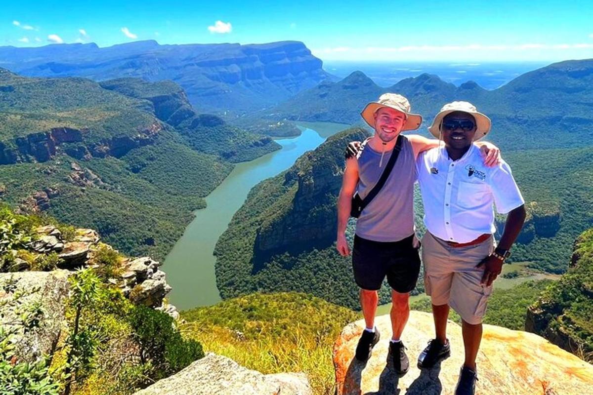 two men standing on top of a mountain