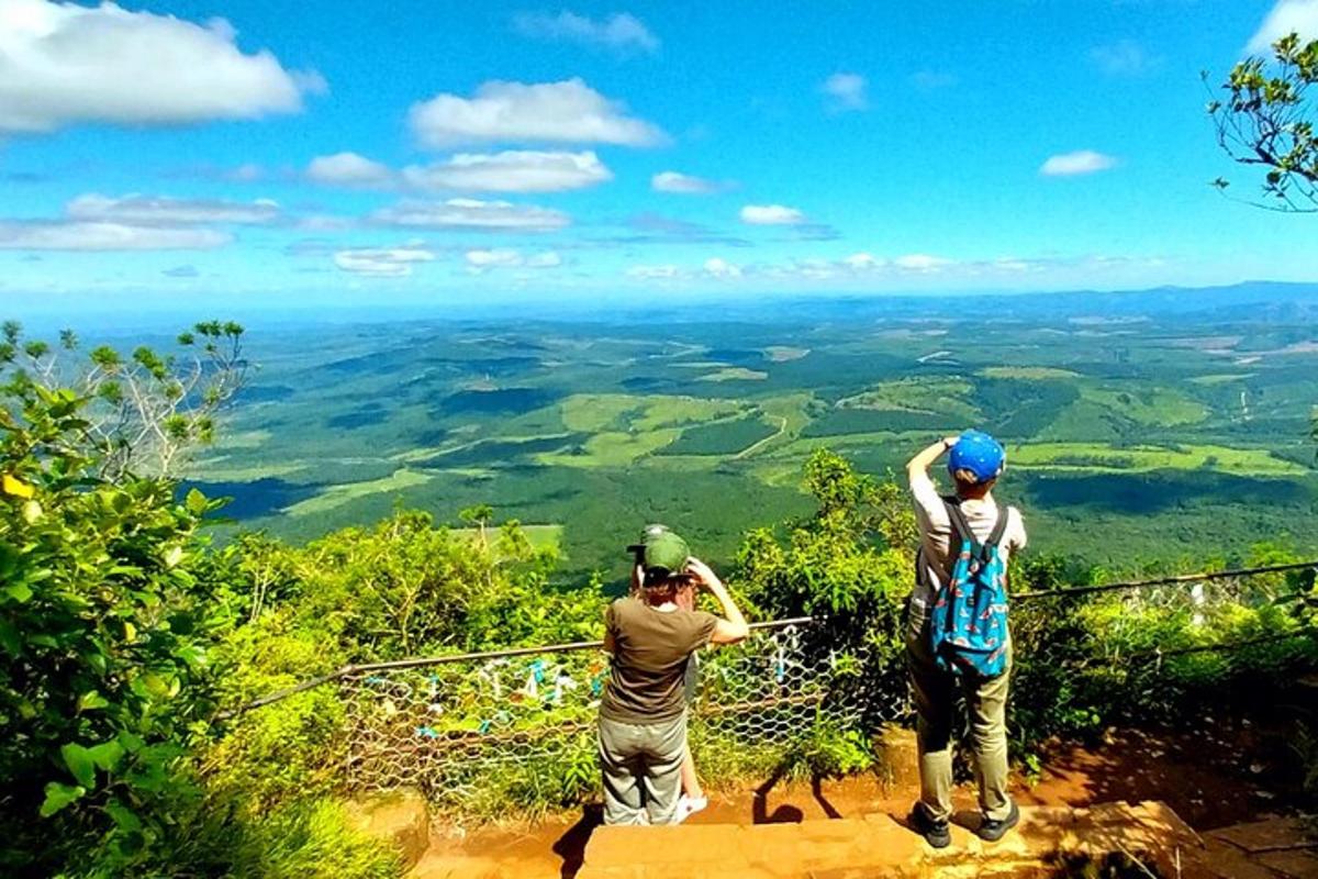 two men standing on top of a mountain
