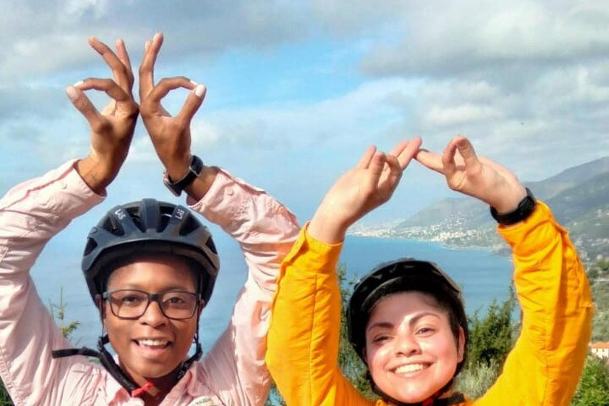two people holding their hands up in the air
