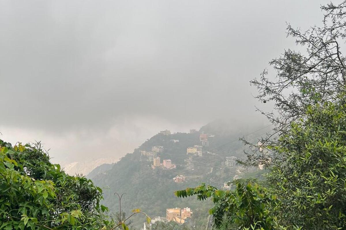 a view of a mountain with houses on a hill