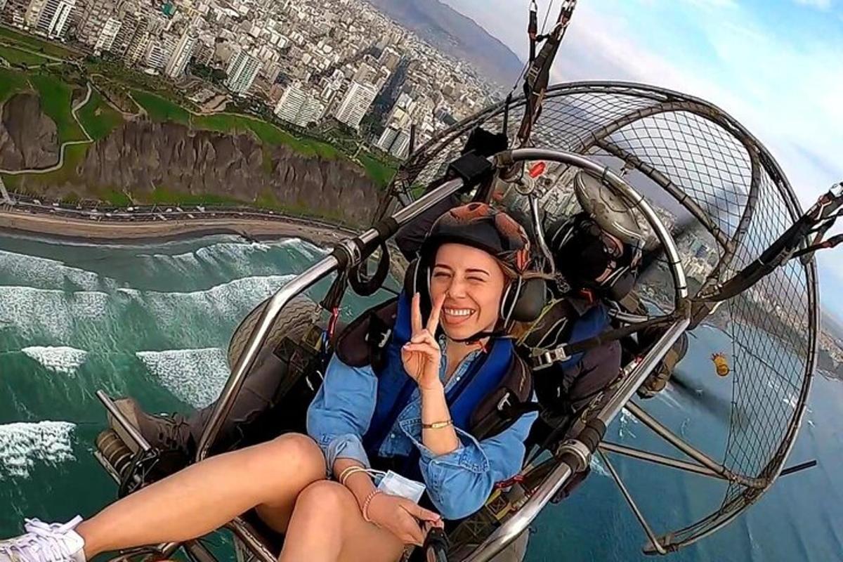 a woman is sitting in a zipline over the water