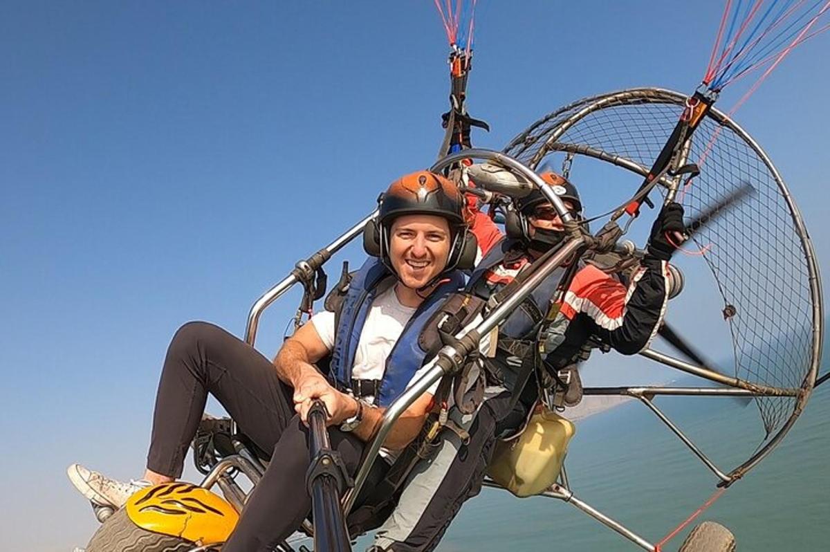a man is riding a parachute in the water