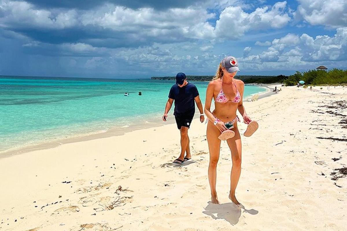 a man and a woman walking on the beach