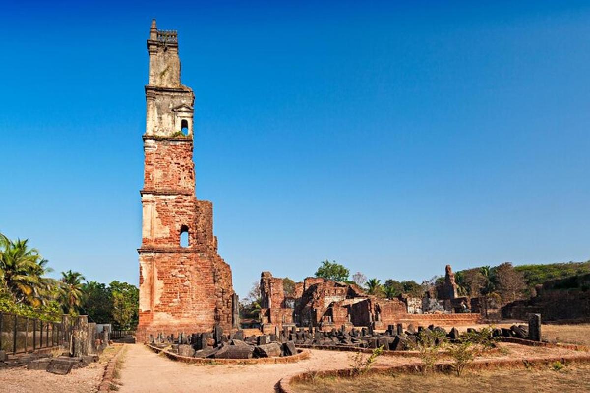 a tall brick tower in the middle of a field
