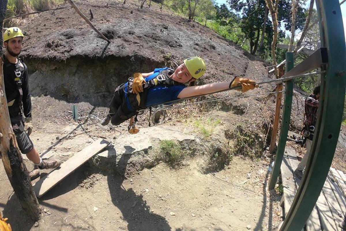 a woman on a rope swing in a obstacle course