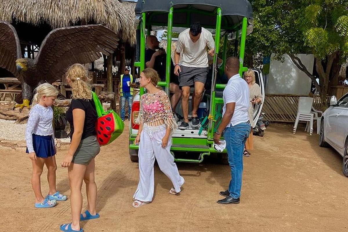 a group of people standing around a green truck