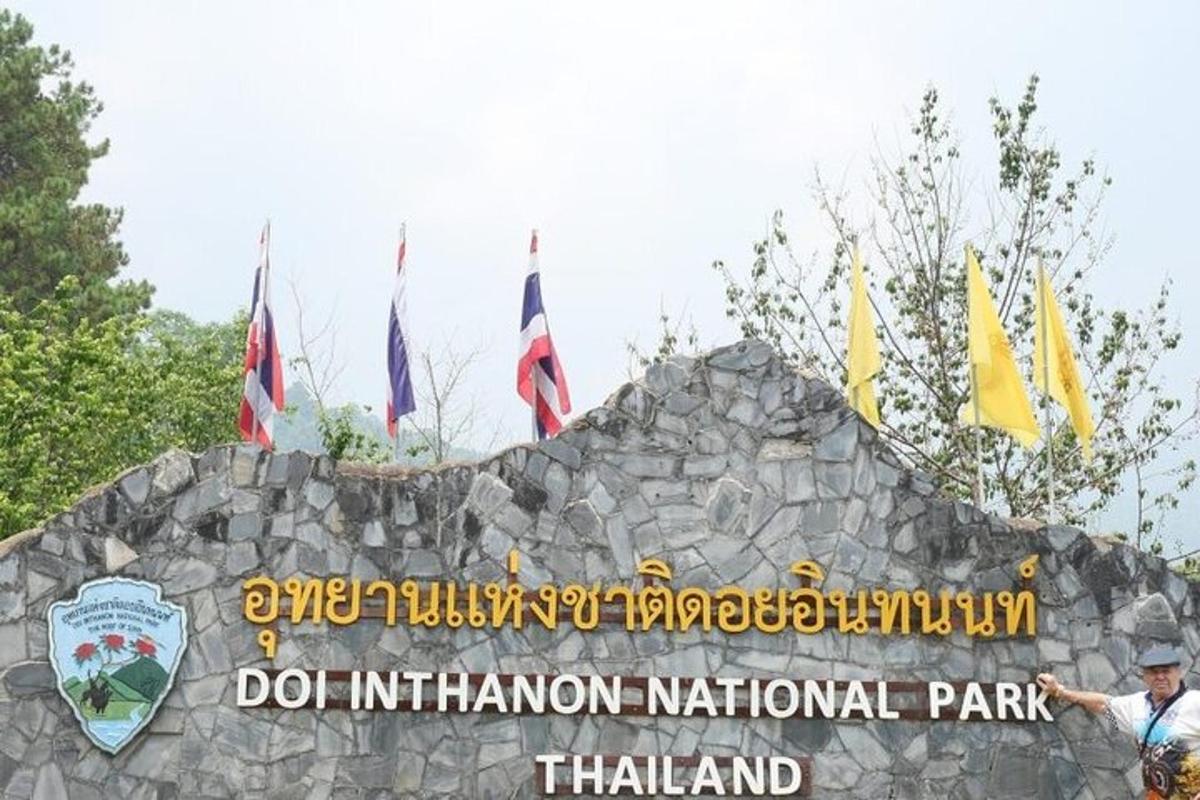 a sign for the doolin national park with flags