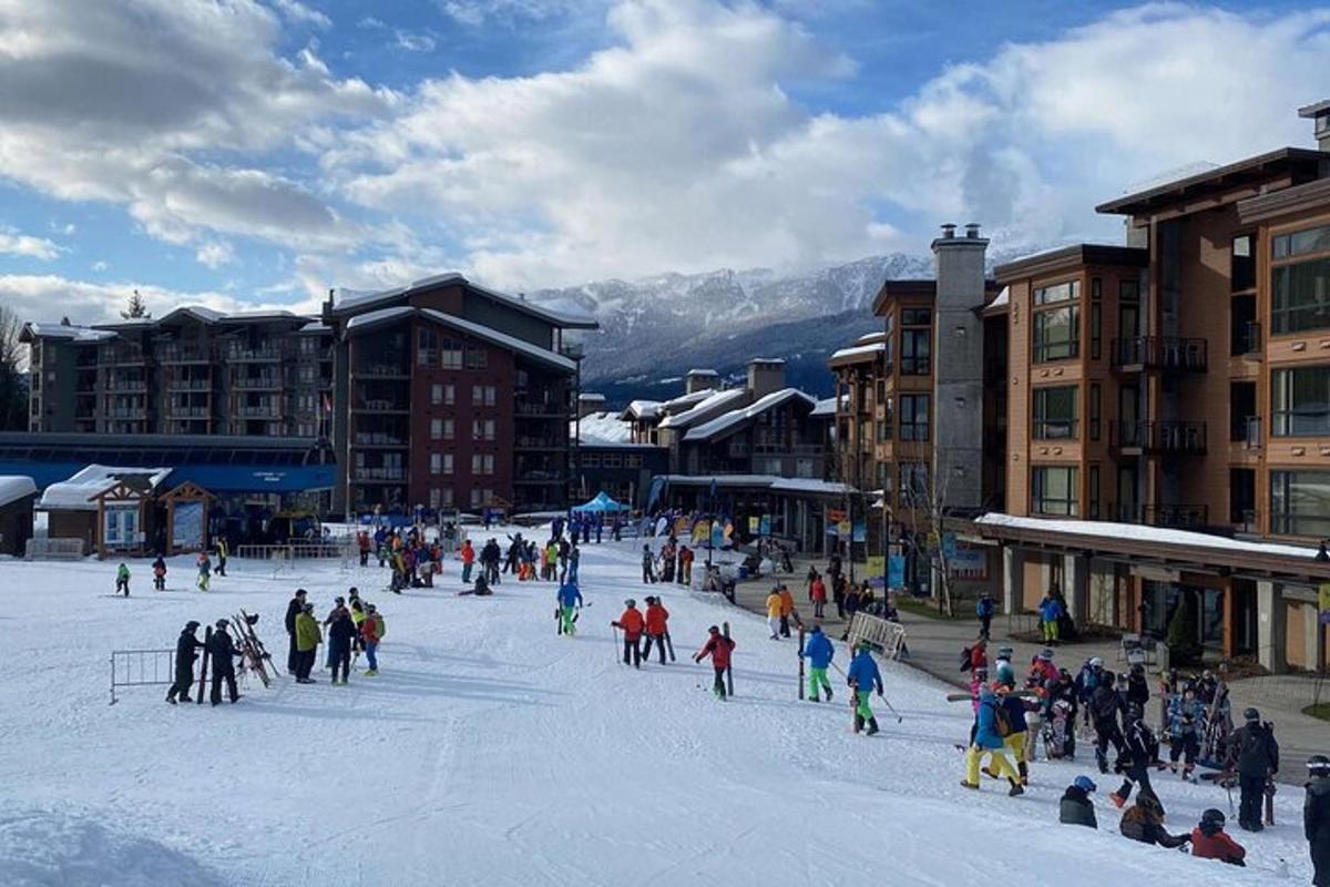a group of people playing in the snow in a town