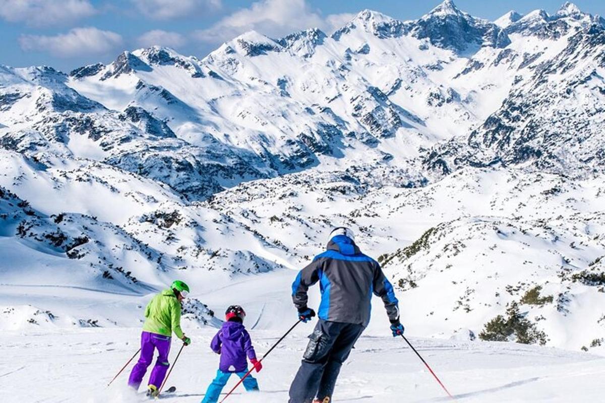 a group of three people skiing on a snow covered mountain