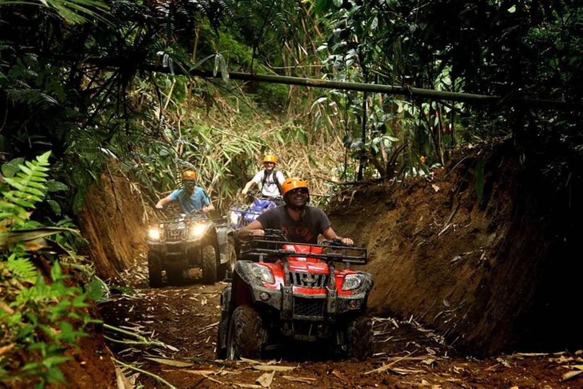 a group of people riding on atvs down a dirt road